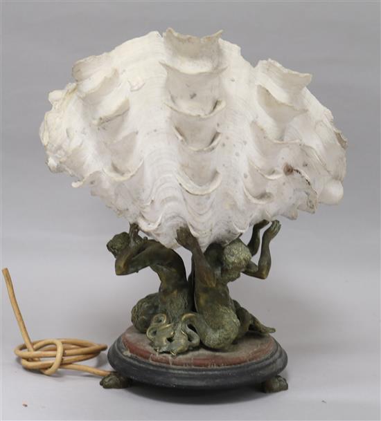 A bronze triton shell lamp